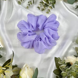 May include: A light purple, fluffy, fabric hair scrunchie.