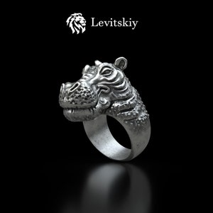 May include: A silver ring with a detailed hippopotamus head design. The ring is made of metal and has a smooth, polished finish.