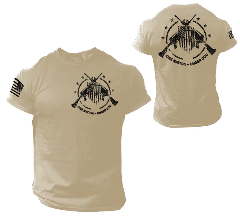 May include: Tan short-sleeved t-shirt with a black and white graphic of crossed rifles, an American flag, and the text "One Nation - Under God". The shirt has a small American flag on the left sleeve.