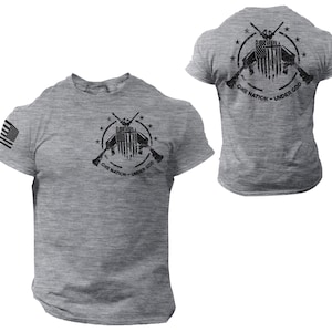 May include: Two gray t-shirts with a black graphic print of crossed rifles and an American flag with the text "One Nation - Under God".