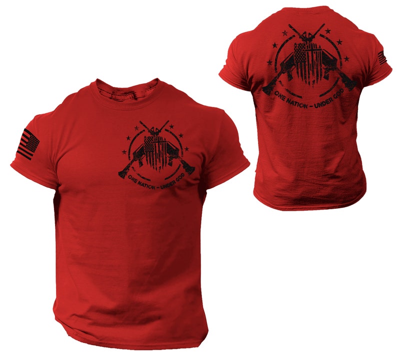 May include: Red t-shirt with a black graphic of crossed rifles, an American flag, and stars. The text "One Nation - Under God" is printed below the graphic.