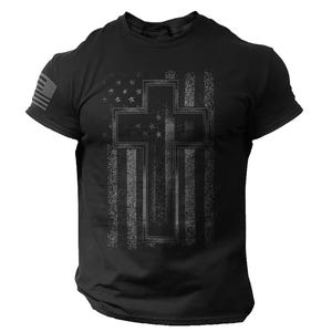 May include: Black t-shirt with a distressed American flag design and a cross overlay. The flag design features stars and stripes, with a cross shape in the centre. The shirt has short sleeves and a crew neck.