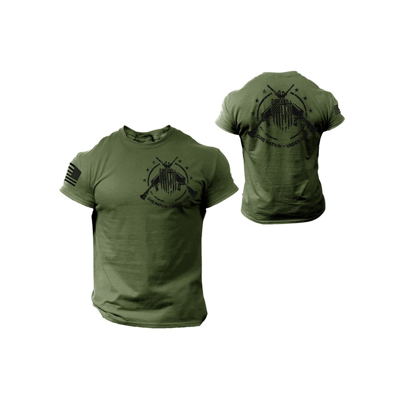 May include: A green t-shirt with a black graphic of two crossed rifles with an American flag in the center. The graphic is surrounded by stars and the text "One Nation - Under God".