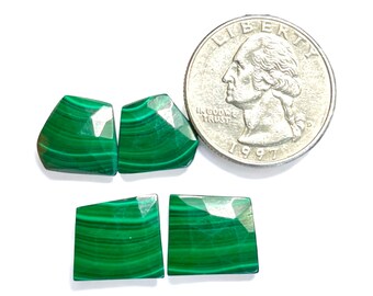 May include: Four green malachite gemstone cabochons, two are rectangular and two are irregular shaped, next to a US quarter for size comparison.