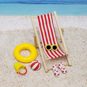 May include: A red and white striped beach chair with yellow sunglasses, a yellow inflatable ring, a red and white beach ball, and red and white flip flops on a sandy beach.