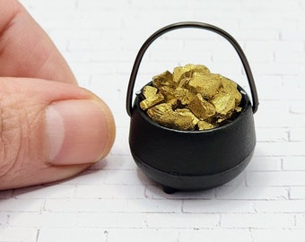 May include: A miniature black cauldron with a handle filled with gold nuggets.