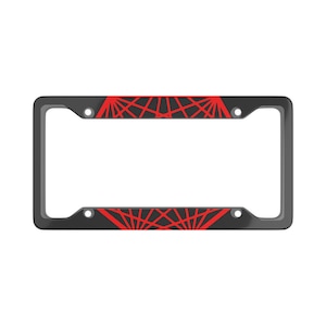 May include: Black license plate frame with a red geometric design. The design resembles a spider web.