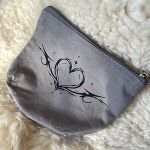 cosmetic bag with tribal heart motif