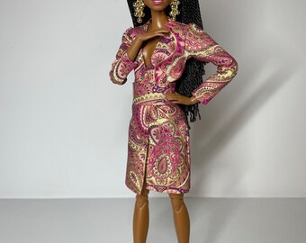 May include: A Black doll with long black braids wearing a pink and gold paisley dress and gold shoes.