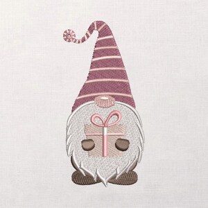 May include: Embroidered gnome design with a long, striped burgundy and white hat and a white beard. The gnome is holding a small gift box tied with a pink bow. The gnome has brown eyes and feet. The design is on a white background.