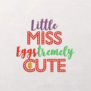 Puede incluir: Diseño bordado sobre tela blanca. El texto dice "Little MISS eggstremely CUTE" en hilo morado, rojo y verde. Las letras están delineadas con pequeños puntos blancos. Un pollito amarillo está dentro de la letra "O".