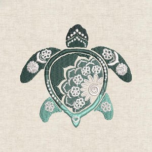 May include: Embroidered sea turtle design in teal and white on a beige background. The turtle has intricate floral patterns within its shell and on its flippers, with a detailed head and a heart-shaped tail.