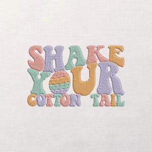 May include: Embroidered design with the text "SHAKE YOUR COTTON TAIL" in pastel colours. The design includes an Easter egg in the centre. The letters are in a retro, groovy font, perfect for Easter.