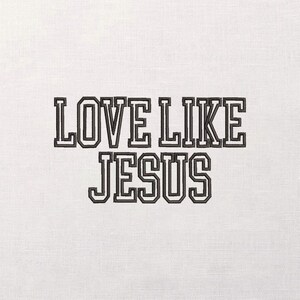 May include: White fabric with the embroidered text "LOVE LIKE JESUS" in a bold, black, collegiate-style font. The text is centered and takes up a significant portion of the frame.