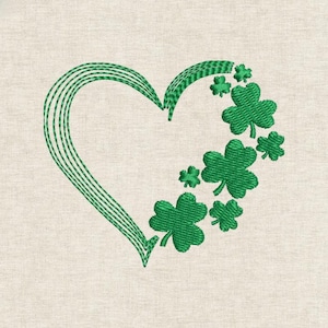 May include: Green embroidered heart design with a cluster of shamrocks on a beige background. The heart is formed with parallel lines, and the shamrocks are detailed with textured stitching, creating a St. Patrick's Day theme.