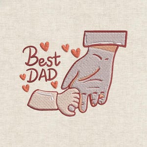 May include: Embroidered design featuring a large hand holding a smaller hand, with the words "Best DAD" in a cursive font. Small orange hearts are scattered around the text. The design is on a beige fabric background.