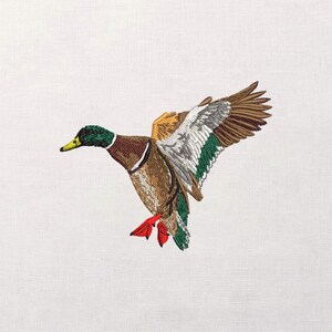 May include: Embroidered image of a mallard duck in flight. The duck features a green head, brown body, and wings with brown, white, and green details. Its red feet are extended, and the background is white.