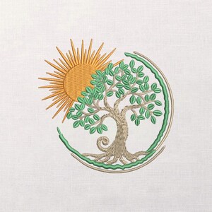 May include: An embroidery design on white fabric featuring a golden yellow sun with radiating rays positioned behind a tree with a tan trunk and green leaves. The tree is partially encircled by a curved green line and a thin tan arc.