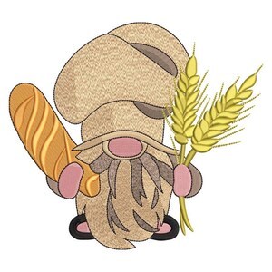 May include: An embroidered gnome design holding a baguette and wheat stalks. The gnome wears a tan hat and has a long, gray beard. The baguette is golden brown, and the wheat is yellow. The design is on a white background.