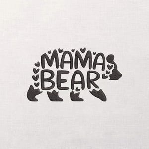 May include: Embroidered design with the text "MAMA BEAR" in a bear shape, with heart details. The design is in dark grey thread on a white background, suitable for various craft projects.