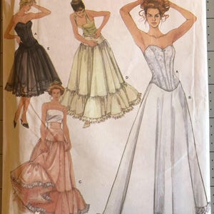 May include: A Simplicity 5006 sewing pattern envelope for misses' lingerie, size RR 14, 16, 18, 20. The cover features illustrations of four different corset-style tops and skirt combinations in black, light green, white, and pink with lace trim.