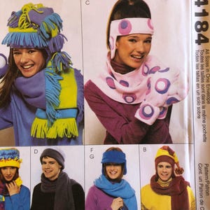 May include: A vintage sewing pattern featuring various winter accessories. The image showcases colorful hats, scarves, and matching sets in shades of blue, yellow, pink, and gray. The text "ACCESSORIES" is visible at the top, with the pattern number "4184" on the right.