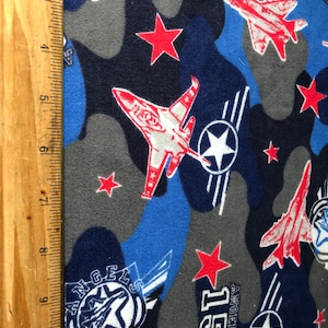 Airplane themed 100 % cotton flannel fabric. Suitable for clothes for kids, pets, dolls or patriotic items.  Fabric by the yard.