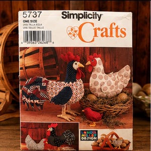 May include: A Simplicity Crafts sewing pattern envelope, number 5737, featuring illustrations of fabric chickens, a rooster, and a small chick. The package displays text including 'Simplicity Crafts' and 'ONE SIZE' with a barcode and product images.