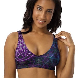 May include: A purple and blue sports bra with a geometric pattern. The pattern features a flower of life design.