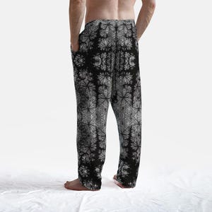May include: Black and white patterned pajama pants with a geometric design. The pants have an elastic waistband and a relaxed fit.