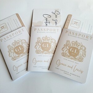 May include: Three passport-style wedding invitations with a gold crest and the text "Passport Wedding Invitation" and "GL 2023" on the front. The invitations are for Grace and Lewis and the wedding is on 12th August 2023 in Fort Lawrence, Dubrovnik, Croatia.