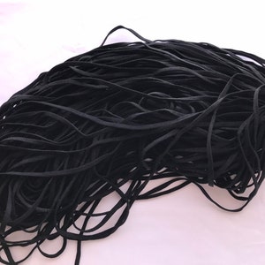 May include: A large pile of black elastic cord, ideal for crafting projects.