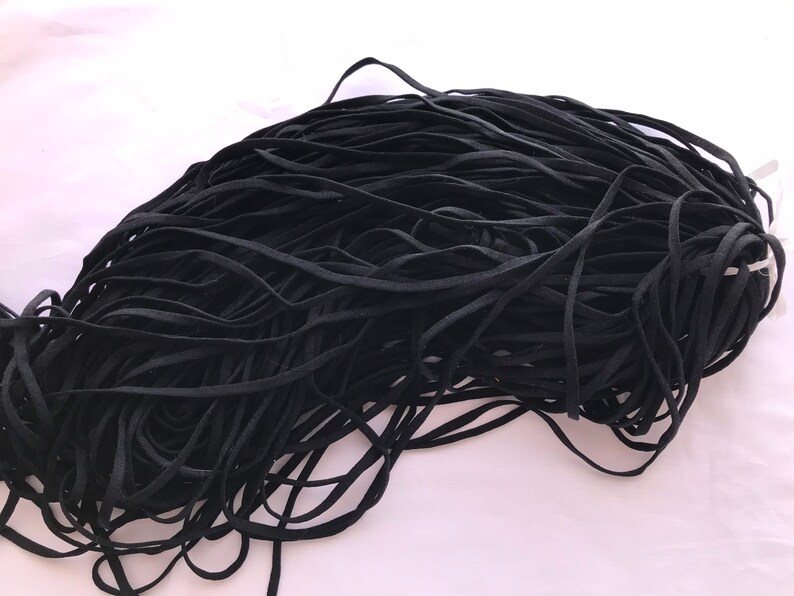 May include: A large pile of black elastic cord, ideal for crafting projects.