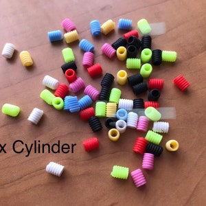 May include: A mix of colorful plastic cylinder beads in various colors, including red, yellow, blue, green, pink, white, and black. The text "Mix Cylinder" is written below the beads.