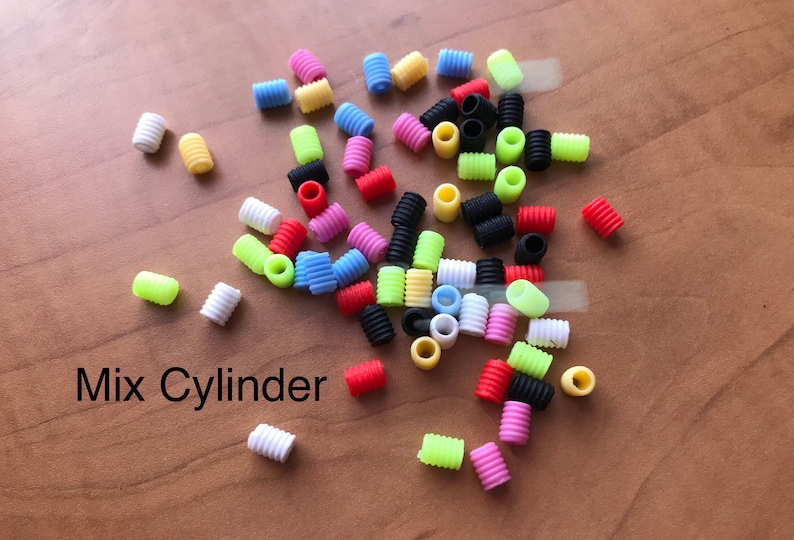 May include: A mix of colorful plastic cylinder beads in various colors, including red, yellow, blue, green, pink, white, and black. The text "Mix Cylinder" is written below the beads.