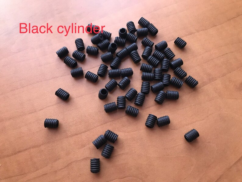 May include: A large quantity of small black rubber cylinder stoppers.