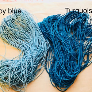 May include: Two spools of elastic cord, one in baby blue and one in turquoise.