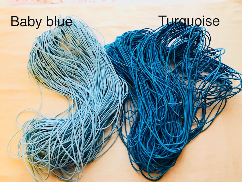 May include: Two spools of elastic cord, one in baby blue and one in turquoise.