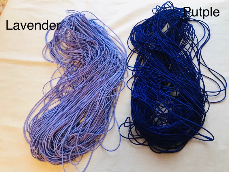 May include: Two spools of elastic cord, one lavender and one dark blue. The spools are labeled "Lavender" and "Purple".