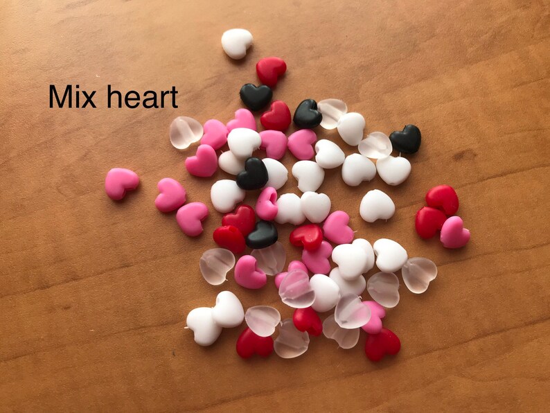 May include: A mix of heart-shaped beads in pink, red, white, black, and clear.  Mix heart.