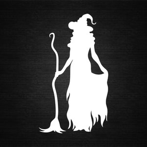 May include: White silhouette of a witch holding a broom, wearing a pointed hat and flowing dress. The witch is depicted in profile, with long hair and a curved broom. The background is a dark wood grain.