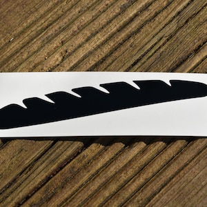 May include: A black silhouette of a baguette on a white background.