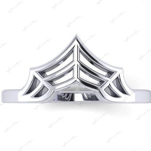 以下が含まれることがあります： 幾何学模様のシルバーリング。リングは1つの金属でできており、先のとがったトップがあります。