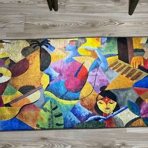 May include: Abstract rug with a colorful design featuring two figures, one playing a musical instrument and the other holding a flower. The rug has a geometric pattern with shades of blue, yellow, red, green, and brown.