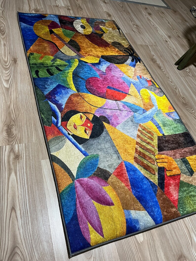May include: Abstract rug with a colorful design featuring geometric shapes, flowers, and a woman's face. The rug has a dark gray border.