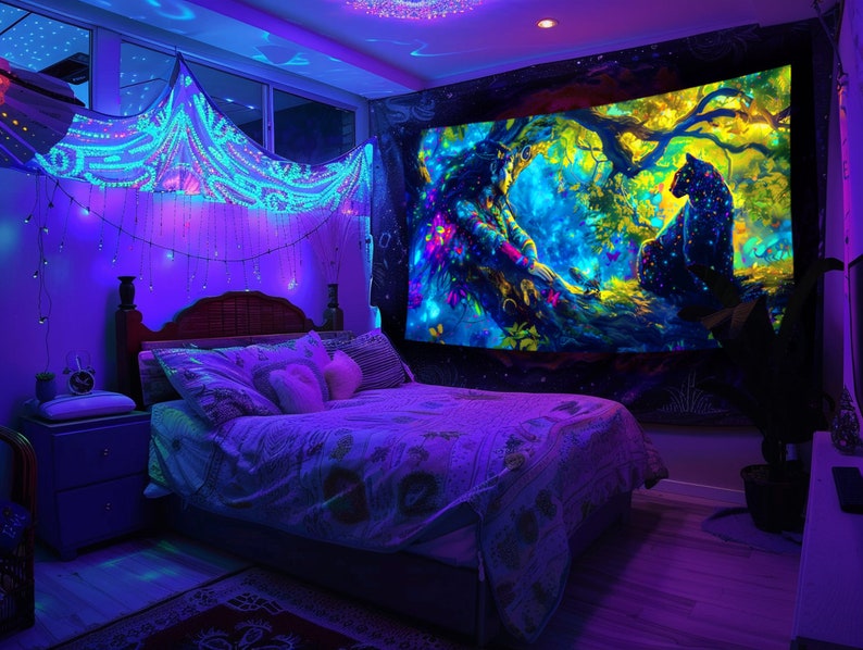 May include: A bedroom featuring a bed, a bedside table, and a tapestry on the wall. The tapestry is a vibrant psychedelic design with a black panther and a tree. The room is illuminated with blue and purple lights.