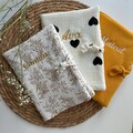 Personalized health record cover with embroidered first name, birth gift product logo