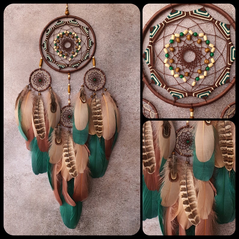 May include: A brown dream catcher with green and brown feathers. The dream catcher has a beaded center and a geometric pattern.