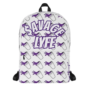May include: White backpack with a purple and white pattern of a cup with a purple liquid spilling out. The text "SAVAGE LYFE" is in a purple and white font.