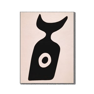 May include: Abstract art print featuring a black, stylized shape against a cream background. The black shape has a curved top, a narrow neck, and a wider, angled body with a white circle in the center. The artwork is framed.